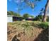 Large backyard with unkempt grass and a screened enclosure at 7304 Dianne Dr, New Port Richey, FL 34652