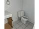 Small bathroom with white toilet and bathtub at 7304 Dianne Dr, New Port Richey, FL 34652