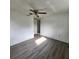Bright bedroom with ceiling fan and grey vinyl flooring at 7304 Dianne Dr, New Port Richey, FL 34652