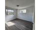 Simple bedroom with grey vinyl flooring and a window at 7304 Dianne Dr, New Port Richey, FL 34652