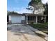 Brick house with a single car garage and a small front yard at 7304 Dianne Dr, New Port Richey, FL 34652
