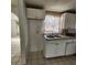 Small kitchen with white cabinets and double sink at 7304 Dianne Dr, New Port Richey, FL 34652