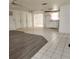 Open living area with grey vinyl and tile flooring at 7304 Dianne Dr, New Port Richey, FL 34652