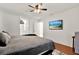 Spacious main bedroom with a king-size bed and hardwood floors at 9143 Bay Dr, Spring Hill, FL 34606