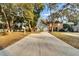 Two story house with a long driveway, surrounded by mature trees at 9402 Forest Hills Cir, Tampa, FL 33612