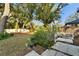 Landscaped backyard with trees and a white picket fence at 9402 Forest Hills Cir, Tampa, FL 33612