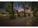 House at dusk with a large backyard surrounded by trees at 9402 Forest Hills Cir, Tampa, FL 33612