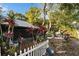 Backyard with tropical plants and a white picket fence at 9402 Forest Hills Cir, Tampa, FL 33612