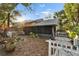 Backyard view of home with screened porch and garden at 9402 Forest Hills Cir, Tampa, FL 33612