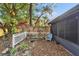 Small backyard with pond, plants, and white fence at 9402 Forest Hills Cir, Tampa, FL 33612