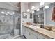 Updated bathroom features a walk-in shower and granite vanity at 9402 Forest Hills Cir, Tampa, FL 33612