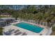 Refreshing community pool with lounge chairs and patio area at 9402 Forest Hills Cir, Tampa, FL 33612