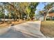 Home's exterior showcasing a long driveway leading to the house at 9402 Forest Hills Cir, Tampa, FL 33612