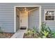 Front entrance with gray siding and landscaping at 9402 Forest Hills Cir, Tampa, FL 33612
