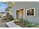 Gray house exterior with walkway and landscaping at 9402 Forest Hills Cir, Tampa, FL 33612