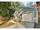 Gray house with attached garage and a nicely landscaped yard at 9402 Forest Hills Cir, Tampa, FL 33612