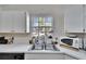 Kitchen features double sink and microwave at 9402 Forest Hills Cir, Tampa, FL 33612