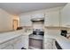 Kitchen with stainless steel range and granite countertop at 9402 Forest Hills Cir, Tampa, FL 33612