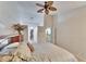 Main bedroom with king bed, ceiling fan and bathroom access at 9402 Forest Hills Cir, Tampa, FL 33612