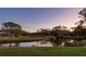 Peaceful backyard oasis with pond and sunset view at 12818 Royal George Ave, Odessa, FL 33556