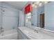 Clean bathroom with light blue tile, white vanity, and bathtub at 12818 Royal George Ave, Odessa, FL 33556