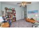 Cozy bedroom with a built-in bookcase and a comfy chair at 12818 Royal George Ave, Odessa, FL 33556