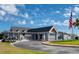 Exterior of clubhouse with golf carts and flag at 12818 Royal George Ave, Odessa, FL 33556