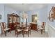 Formal dining room featuring a large table, hutch, and chandelier at 12818 Royal George Ave, Odessa, FL 33556