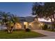 Two-story house with attached garage, landscaping, and palm trees at 12818 Royal George Ave, Odessa, FL 33556