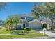 Two-story house with gray siding, palm trees, and a two-car garage at 12818 Royal George Ave, Odessa, FL 33556