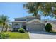 Two-story house with attached garage and landscaping at 12818 Royal George Ave, Odessa, FL 33556