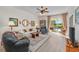 Bright living room with hardwood floors, comfortable seating, and sliding glass doors leading to a pool view at 12818 Royal George Ave, Odessa, FL 33556