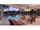 Spacious covered patio with seating overlooking pool at 12818 Royal George Ave, Odessa, FL 33556