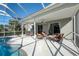 Spacious covered patio adjacent to the pool, perfect for outdoor entertaining at 12818 Royal George Ave, Odessa, FL 33556