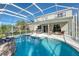 Relaxing pool and patio area with screened enclosure and plenty of seating at 12818 Royal George Ave, Odessa, FL 33556