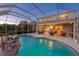 Inviting screened pool and patio area with water feature at 12818 Royal George Ave, Odessa, FL 33556