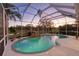 Relaxing screened in pool area at sunset at 12818 Royal George Ave, Odessa, FL 33556