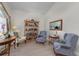 Cozy sitting area featuring comfortable armchairs and a built-in bookcase at 12818 Royal George Ave, Odessa, FL 33556