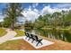Pathway along tranquil lake with bench at 12818 Royal George Ave, Odessa, FL 33556