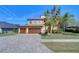 Two-story house with a three-car garage and paver driveway at 13181 Linzia Ln, Spring Hill, FL 34609