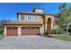 Two-story house with a three-car garage and paver driveway at 13181 Linzia Ln, Spring Hill, FL 34609
