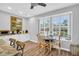 Charming breakfast nook with white table and chairs, and a view to the outdoors at 1373 Curlew Rd, Dunedin, FL 34698