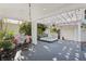 Inviting backyard deck featuring a hot tub, patio furniture, string lights, and lush tropical plants at 2001 Beach Se Dr, St Petersburg, FL 33705