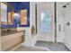 This renovated bathroom features a tiled shower with updated fixtures and vanity at 2001 Beach Se Dr, St Petersburg, FL 33705