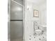 Bathroom features a frosted glass shower, modern toilet, and traditional white paneled wall trim at 2001 Beach Se Dr, St Petersburg, FL 33705