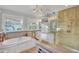 Spa-like bathroom with luxurious soaking tub and glass-enclosed shower at 2001 Beach Se Dr, St Petersburg, FL 33705