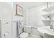 Traditional bathroom with a toilet, sink, framed artwork, and traditional white paneled wall trim at 2001 Beach Se Dr, St Petersburg, FL 33705