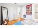 Bright bedroom with a large mirror, colorful wall hanging, and doorway to an adjacent room at 2001 Beach Se Dr, St Petersburg, FL 33705