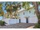 Light blue home with white fence, two car garage, and lush tropical landscaping at 2001 Beach Se Dr, St Petersburg, FL 33705