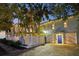 Beautiful home exterior with lush trees, a private driveway, and a white picket fence at 2001 Beach Se Dr, St Petersburg, FL 33705